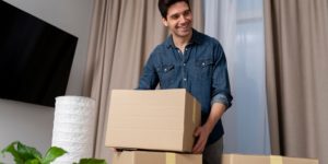 Man unpacking belongings after moving into a new home